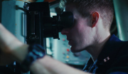 A United States Navy Submarine Officer monitors surface activity aboard a submarine.